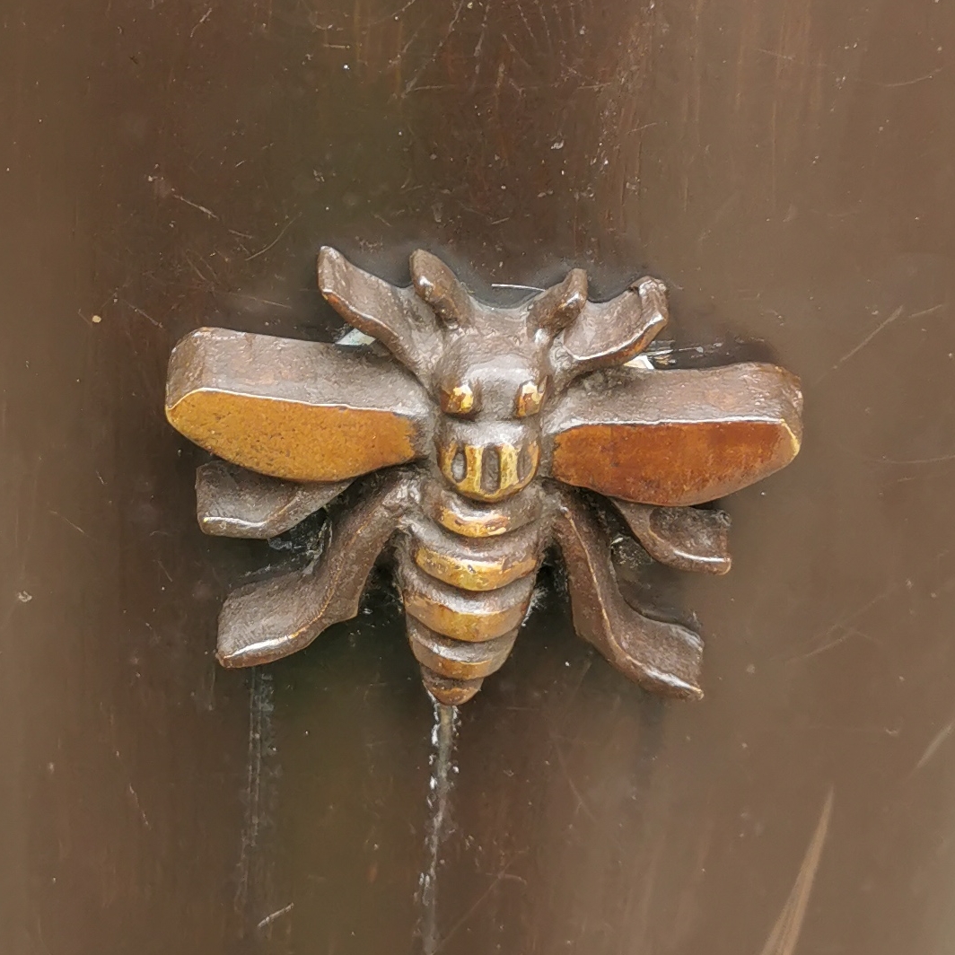 Bee on gate post at Library Walk
