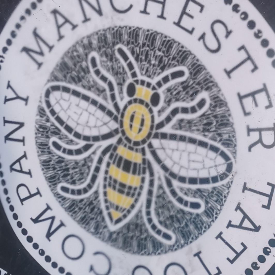 Bee on Manchester Tatoo Company shop A sign on Oldham Street