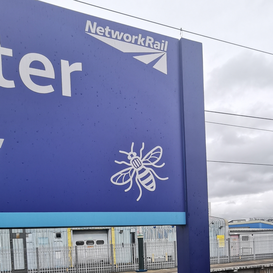 Bee on sign at Manchester Piccadilly railway platform