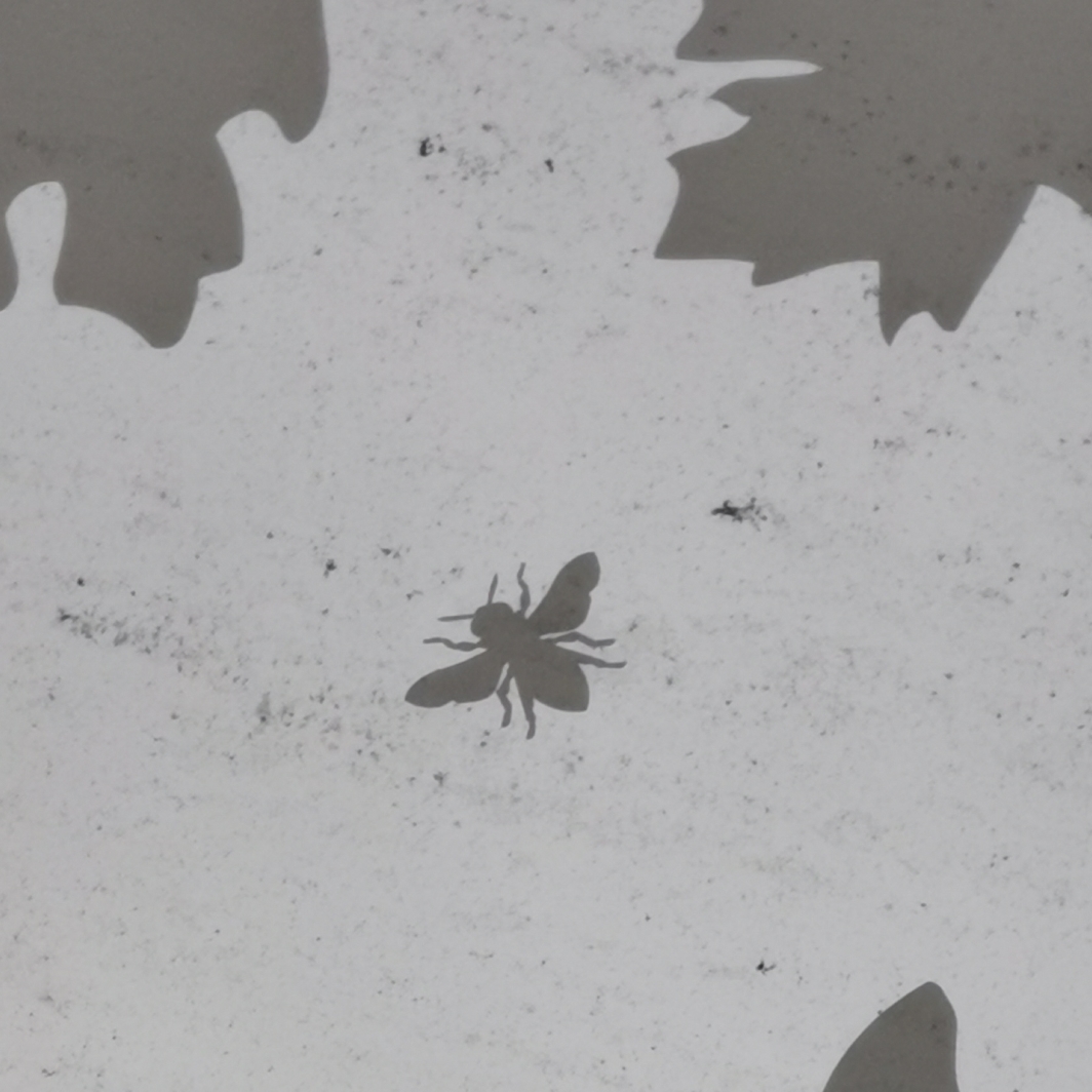 Bee and leaves in glass canopy at Deansgate / Castlefield tram stop