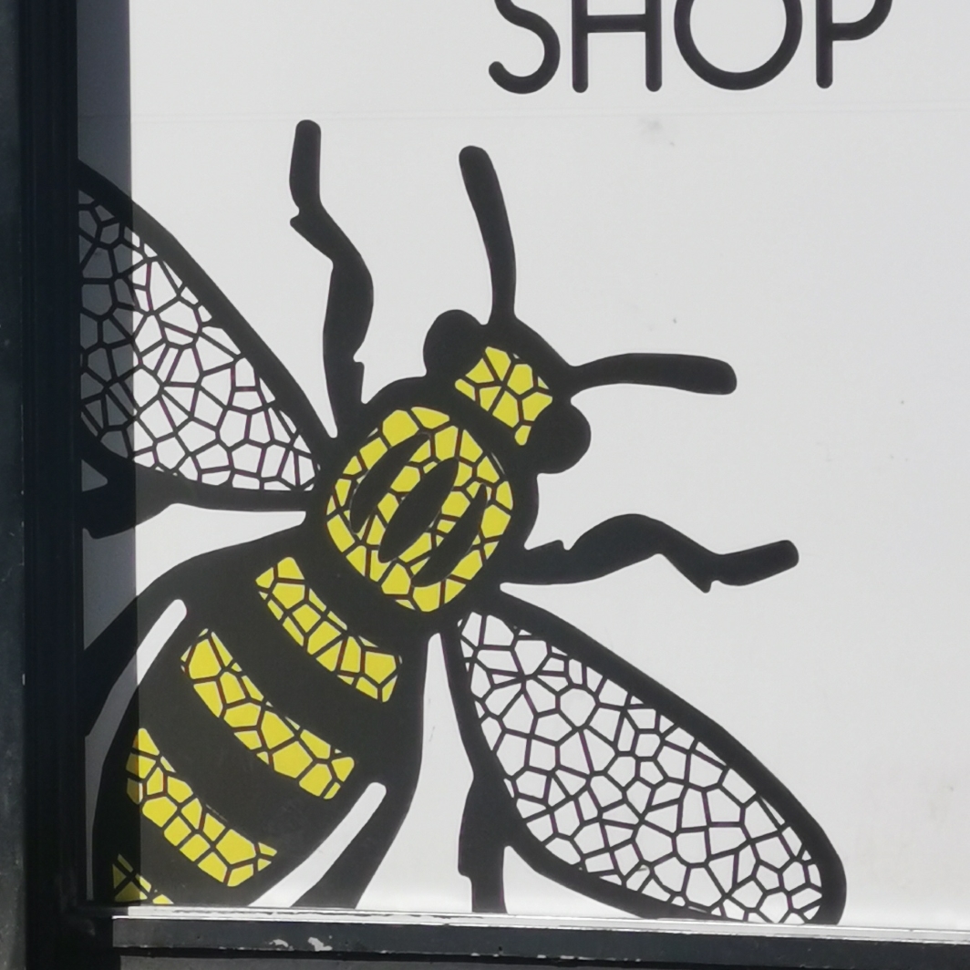Bee on signage at The Manchester Shop, Oldham Street