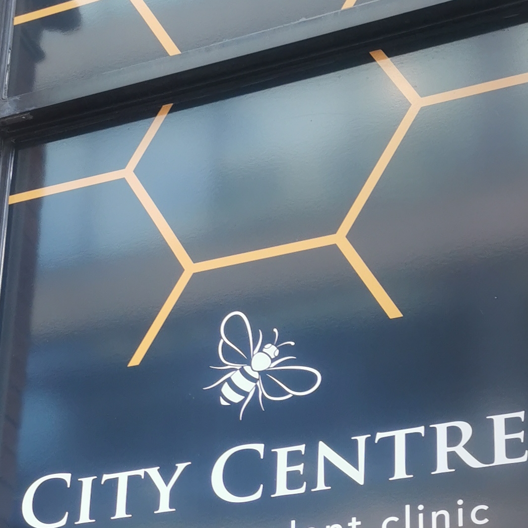 Bee on window sign at dental clinic, Booth Street