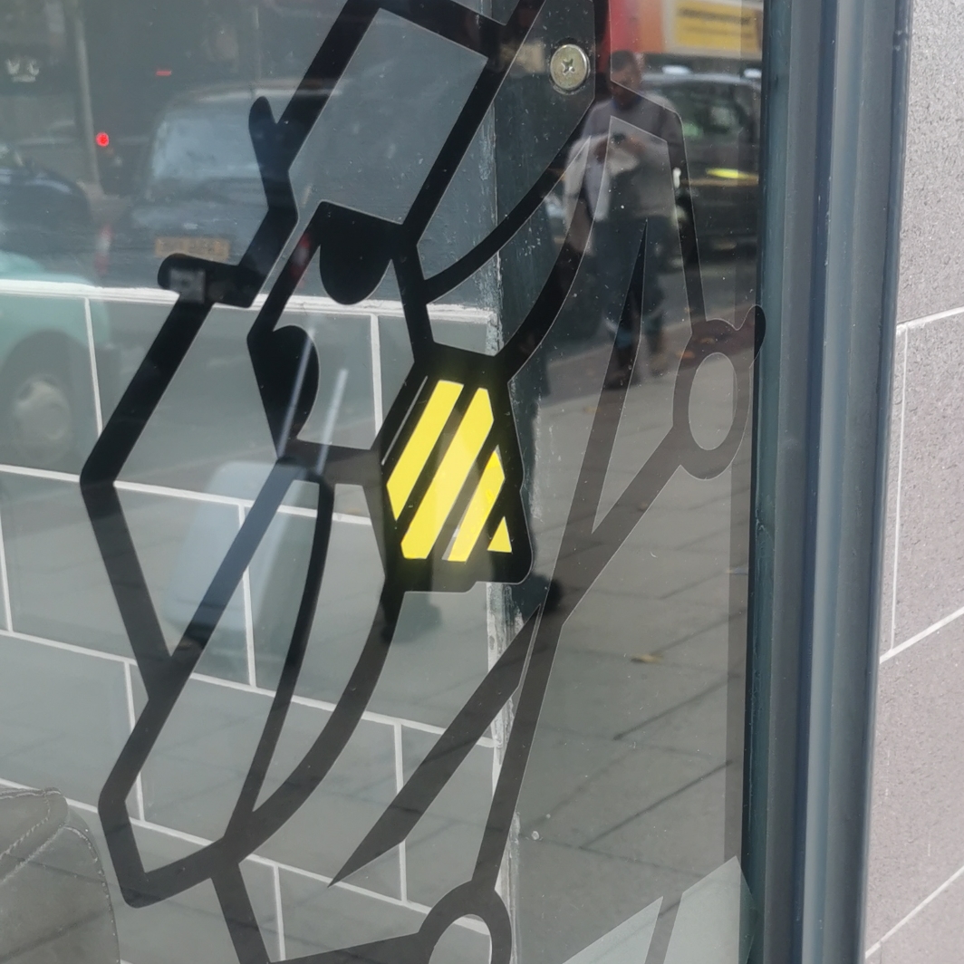 Bee in the window at Mancunian Barbers, Piccadilly