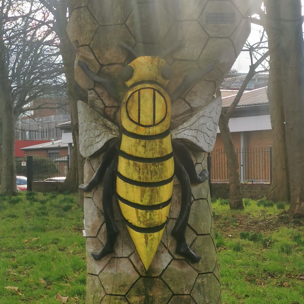Wooden bee sculpture at Garside Gardens near Upper Brook Street