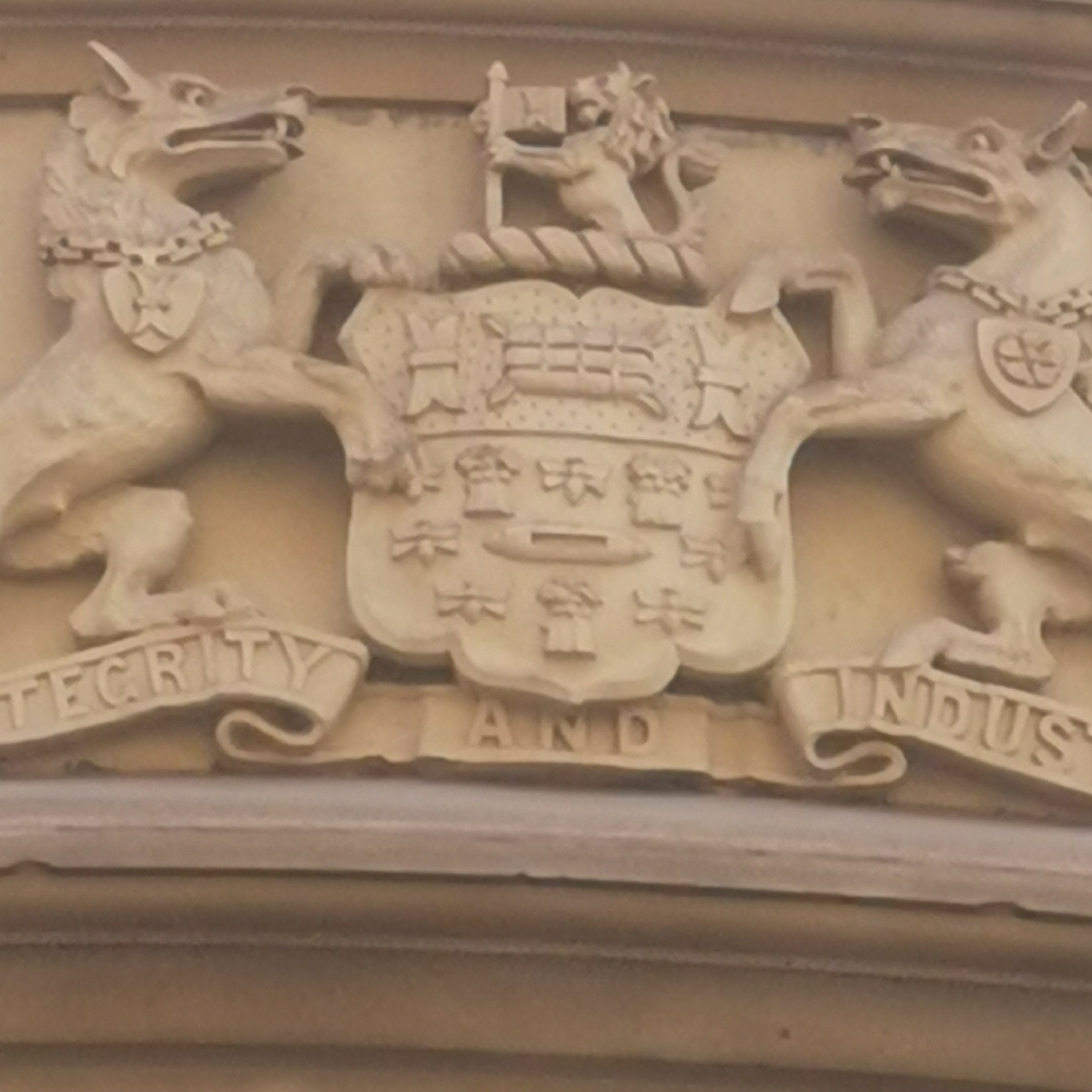 Close up of bees on Salford coat of arms Portland House, Princess Street