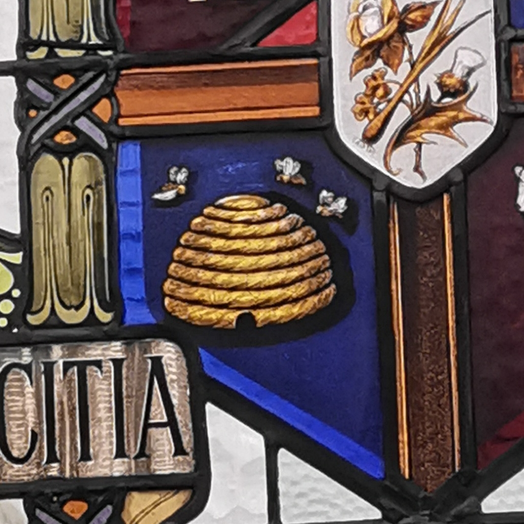 Close up of stain glass window beehive and bees on Oddfellows coat of arms, inside Oddfellows Hall, Grosvenor Street