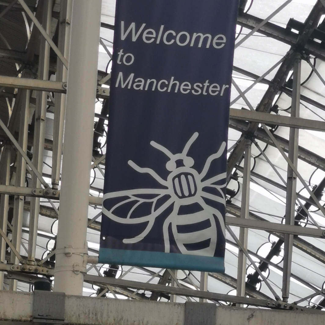 Manchester bee on welcome banner at Manchester Piccadilly train station